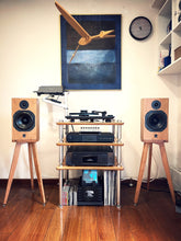 Load image into Gallery viewer, Home audio system with wooden ATC SCM11 speakers on audio chic speaker stands and a shelf in a room.