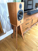 Load image into Gallery viewer, Wooden speaker on a heron speaker stand by audio chic in a room with a dresser and decorative items.