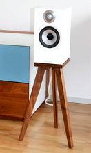 Load image into Gallery viewer, B&amp;W 607, 607 S2 and 607 S3 speaker stands in walnut in a living room. White speaker on a wooden stand against a white wall