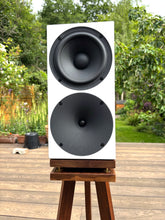 Load image into Gallery viewer, Speaker on a stand outdoors with greenery in the background