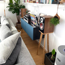 Load image into Gallery viewer, Dali Zensor 3 speaker stands in a Living room with a grey sofa, bookshelf, and record player