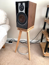 Load image into Gallery viewer, Dali-opticon-2-Bittern-with-isolation-plinths-by-audio-chic. Wooden speaker stand with a black speaker on a carpeted floor.