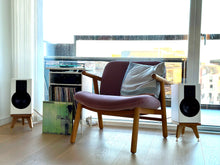 Load image into Gallery viewer, Modern armchair with speakers and audio chic Drunken Snipe speeaker stands, books in a room with large windows