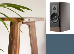 Wooden speaker stand with Dynaudio Contour 20i speakers on a white background