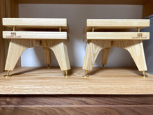 Load image into Gallery viewer, Two wooden audio stands with &#39;Audio Chic&#39; branding on a wooden surface. Harbeth-P3ESR-snipe-Speaker_Stands-with-iso-in-ash-by-audio-chic