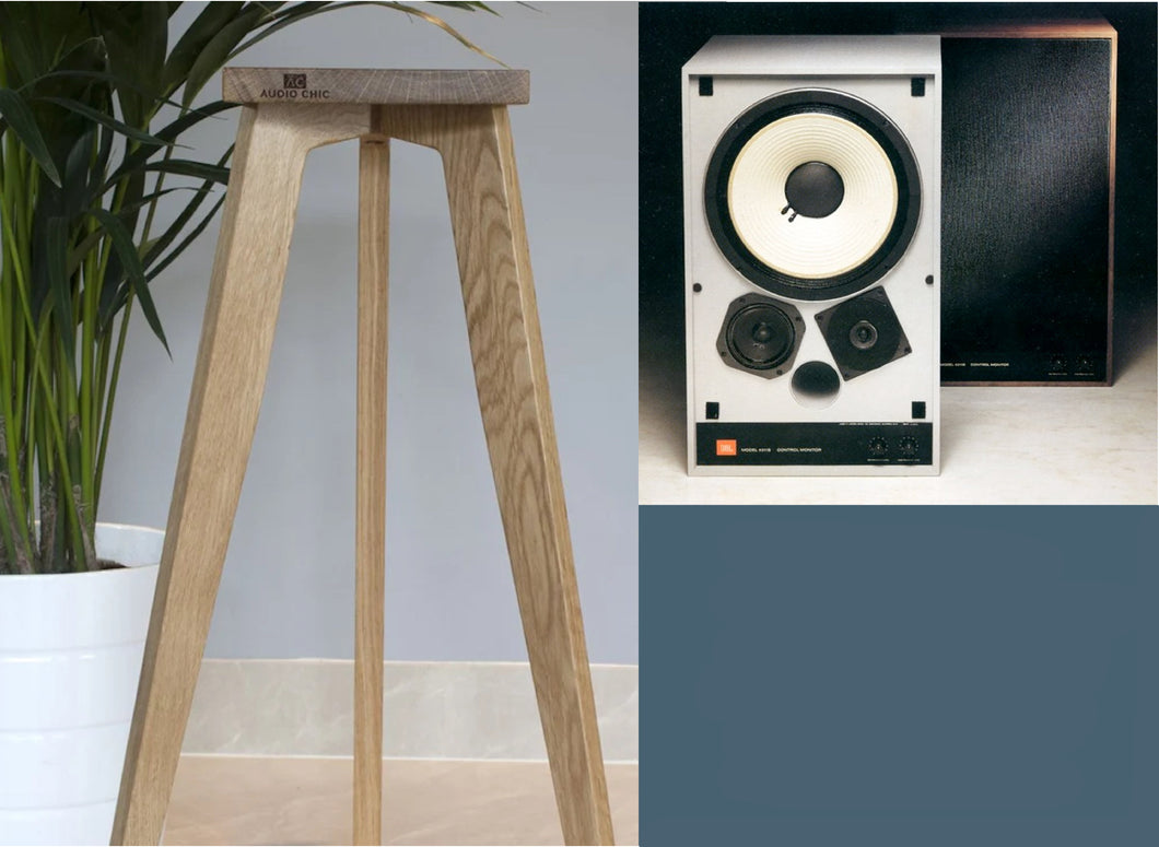 A set of JBL speaker stands made of wood, in a natural finish, with the ability to adjust in height. The stands are designed to support JBL speakers and are pictured alongside a JBL speaker.