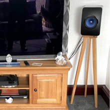Load image into Gallery viewer, Wooden TV stand with a television and a KEF LS50W speaker on a crane speaker stand by Audio Chic in a room.