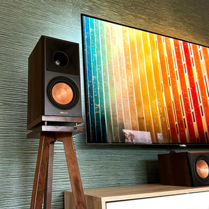 Klipsch-RP500M-II-Walnut-700-speaker-stand-by-audio-chic with TV against a textured wall