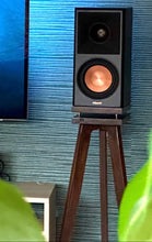Load image into Gallery viewer, Klipsch-RP500M-II-Walnut-with-plinths-speaker-stands-by-audio-chic against a blue textured wall