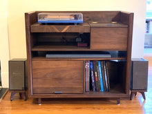 Load image into Gallery viewer, Wooden record player console with Klipsch The Fives snipe speaker stands in walnut and records on a wooden floor.