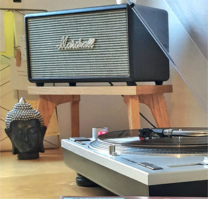 Marshall speaker on a centre speaker stand by Audio Chic with a turntable below it, featuring a Buddha statue.