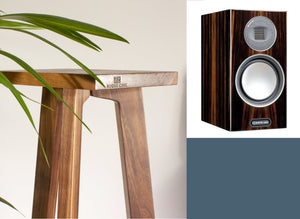 Wooden speaker stand with Shaped Monitor Audio Gold 100 5G speakers on a neutral background