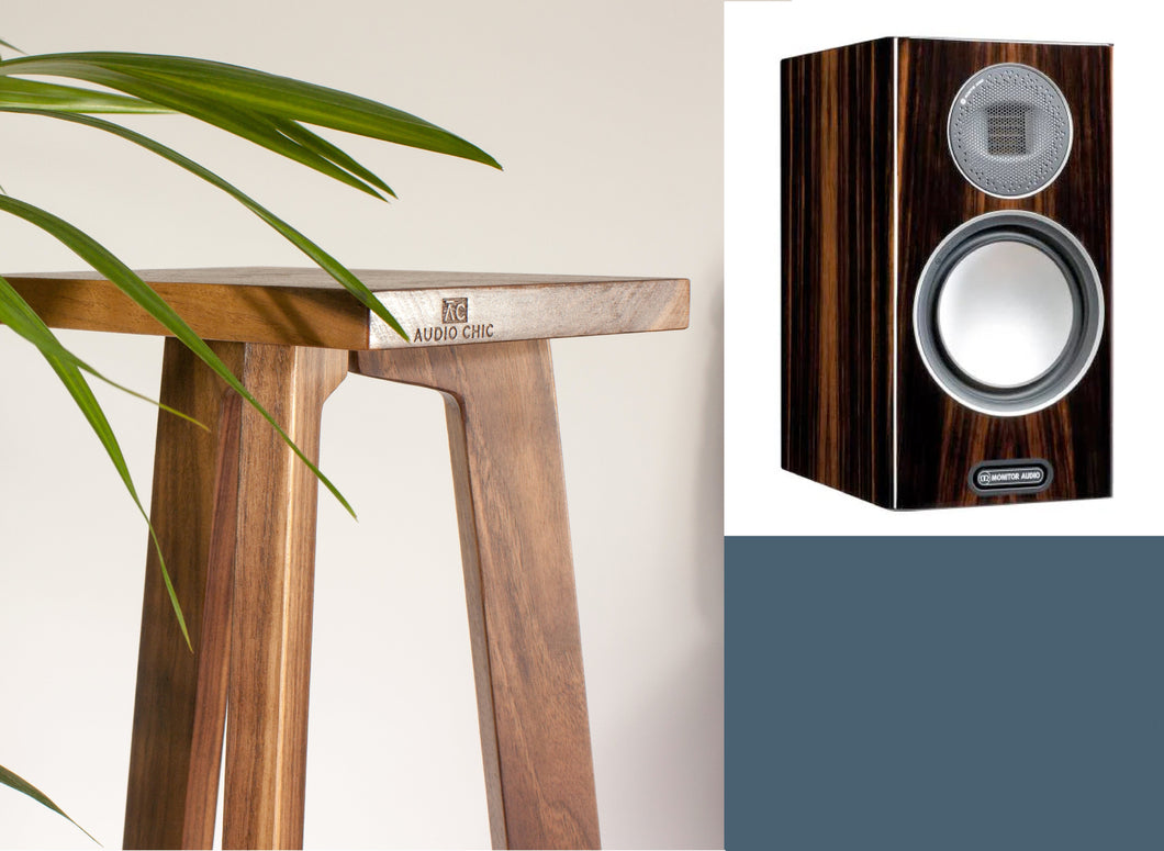 Wooden speaker stand with Shaped Monitor Audio Gold 100 5G speakers on a neutral background