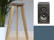 Load image into Gallery viewer, A pair of Mordaunt Short M10 speaker stands made of oak wood, shown in a home setting with one stand braced and the other in a folded position. The speaker stands are designed to be adjustable in height from 140-900mm.