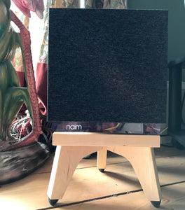 Naim-Audio-Mu-so-Qb-2nd-generation-Speaker_Stands-in-maple-by-audio-chic with a decorative background