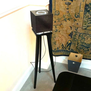 Naim-Audio-Mu-so-Qb-2nd-generation-Speaker_Stands-in-maple-by-audio-chic with a decorative rug in the background.