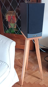 PMC-DB1-heron-700-speaker-stand-in-cherry-by-audio-chic in a room with a couch and decorative items.