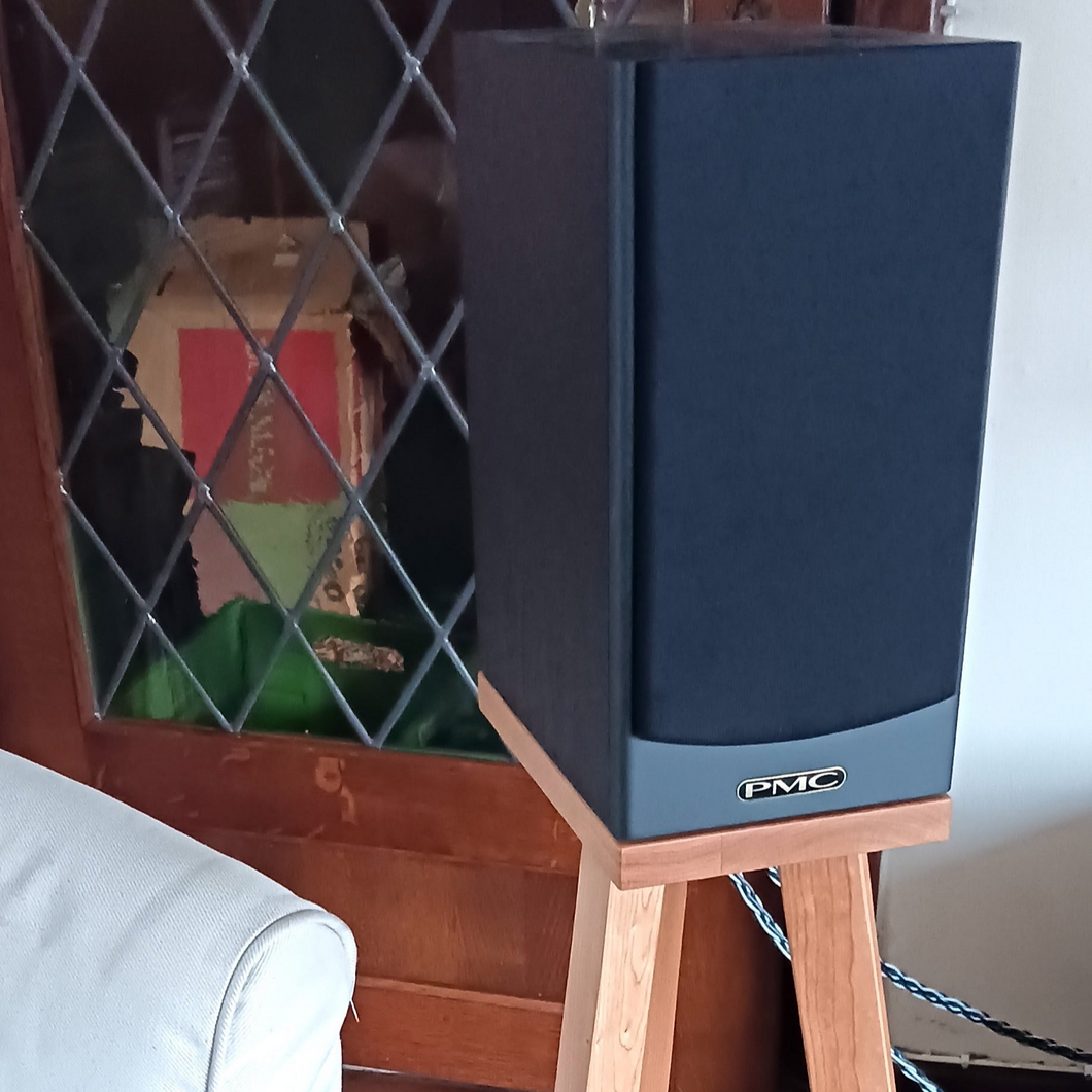 PMC-DB1-heron-700-speaker-stand-in-cherry-by-audio-chic with a cabinet in the background