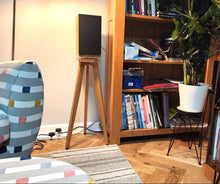 Load image into Gallery viewer, Pro-ject-speaker-box-5-S2-The-Heron-700-Oak-with-Plinths-from-audio-chic in a Living room with a colourful armchair, bookshelf, and record player.