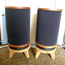 Load image into Gallery viewer, Rogers-hifi-JR149-circular-snipe-speaker-stand-by-audio-chic with a white wall and blue door in the background.