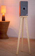 Load image into Gallery viewer, Ruark-Audio-MRX-Crane-speaker-stand-by-audio-chic-cropped with a warm-toned lamp in the background