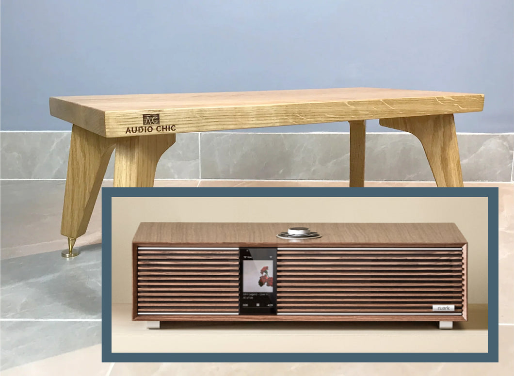 Wooden Centre Speaker stand with 'Audio Chic' branding on a tiled floor with the Ruark R410 Intergrated Music System.