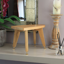 Load image into Gallery viewer, Wooden stool on a shelf with decorative items including a candle and diffuser.