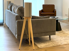 Load image into Gallery viewer, Modern living room with gray sofa, brown armchair, and wooden side table and a Sony hT-A9 speaker on a wooden speaker stand by audio chic