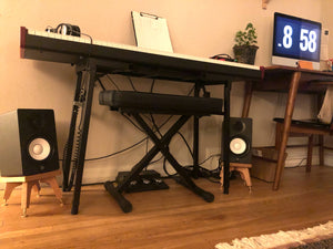 Yamaha-HS5-drunken-kite-speaker-stand-in-cherry-by-audio-chic in a music room with an electronic piano and workstation.