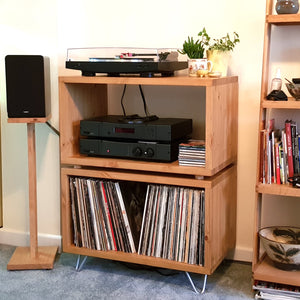 Wooden entertainment console with records, and a harmony-AE-100-speaker-stand-by-audio-chic-for-AE-100-speakers