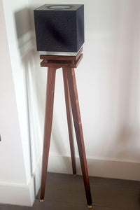 Naim-Audio-Mu-so-Qb-2nd-generation-Speaker_Stands-in-maple-by-audio-chic against a white wall.