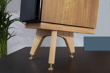 Load image into Gallery viewer, A single Desktop speaker stand made of oak wood, featuring a sloping design with brass speaker spikes and a speaker placed on top.