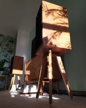 Load image into Gallery viewer, Harbeth C7ES3 Speakers Perfectly Seated on Cherry wood speaker stands in a living room next to a sideboard and tv.