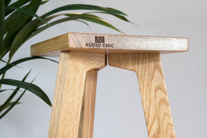 The Crane Solid Oak Speaker Stand tri-leg design.