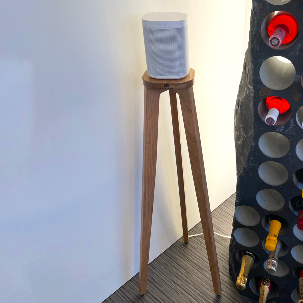 Sonos One Solid Oak Wooden Speaker Stand with a Shaped Top Plate by audio chic with a chunky wine bottle display unit.