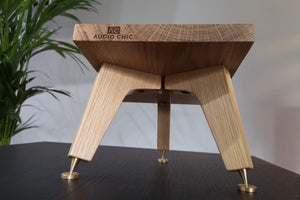 Audio Chic solid oak angled speaker stand with speaker spikes and shoes for audio enhancement.